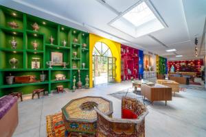 a room with green and colorful walls and furniture at Jnane Rihane Marrakech in Marrakesh +134 photos