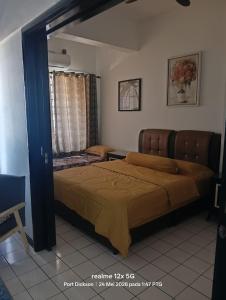 a bedroom with a large bed in a room at Adira Corus Paradise Seaview Family Suite in Port Dickson
