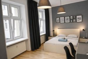 a bedroom with a bed with a teddy bear on it at Amulet Poznan Old Town in Poznań