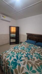 a bedroom with a bed with a colorful comforter at Villa Salguero in Gaira