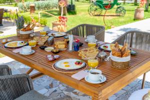 a wooden table with breakfast food on it at Jnane Rihane Marrakech in Marrakesh