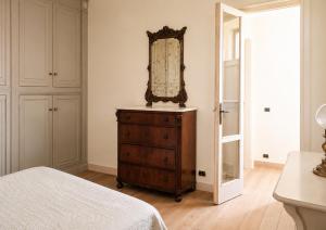 a bedroom with a mirror on top of a dresser at Mare di Gioia in Viareggio