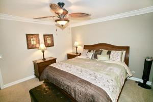 a bedroom with a bed and a ceiling fan at D11 - Beachfront Luxury in Oceanside +41 photos