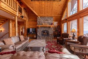 a living room with couches and a stone fireplace at Good Day Sunshine in Lenoir