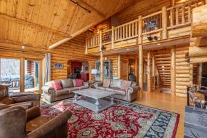 a living room with couches and a table in a cabin at Good Day Sunshine in Lenoir