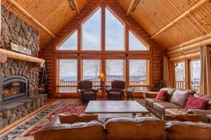 a living room with a fireplace in a log cabin at Good Day Sunshine in Lenoir +43 photos