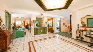 a large living room with a tv and a table at Hotel Kyrton in Forte dei Marmi