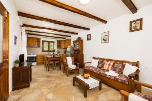 a living room with a couch and a table at Villa Old Vineyard in Kontogiannátika