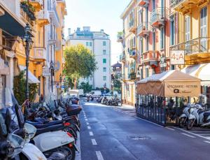 a row of motorcycles parked on a city street at Sanremo Apartments - Orchidea in Sanremo