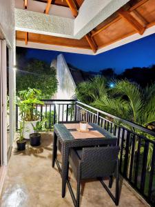 a patio with a table and chairs on a balcony at Hazel's Suites in Dauin +14 photos