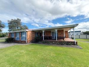 a brick house with a lawn in front of it at Mountain View Hat Head - Bring your own linen. in Hat Head