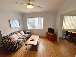 a living room with a couch and a table at Mountain View Hat Head - Bring your own linen. in Hat Head
