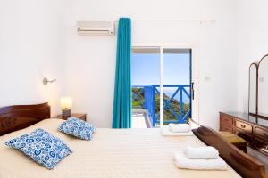 a bedroom with a large bed with a large window at Panorama Villa in Pomos +20 photos