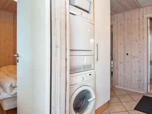 a laundry room with a washer and dryer at Luxury Retreat in Hejlsminde in Hejls