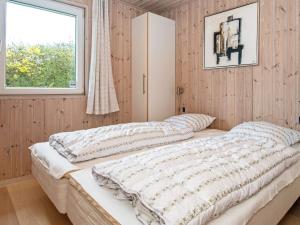 two beds in a bedroom with a window at Luxury Retreat in Hejlsminde in Hejls +21 photos