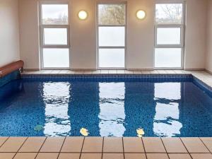 a swimming pool in a room with windows at Luxury Retreat in Hejlsminde in Hejls