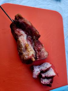 a piece of meat sitting on top of a red plate at Donghae Mookhoae Pension in Donghae