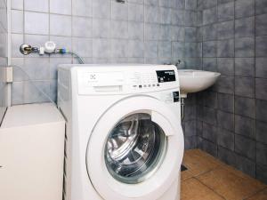 a washing machine in a bathroom with a sink at Charming Stay in Ringkobing in Ringkøbing