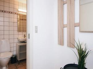 a bathroom with a toilet and a sink at Charming Stay in Ringkobing in Ringkøbing +29 photos