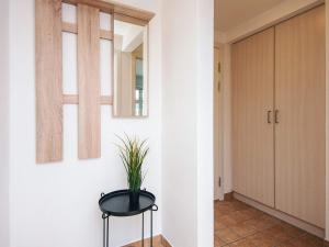 a hallway with a black stool with a plant on it at Charming Stay in Ringkobing in Ringkøbing