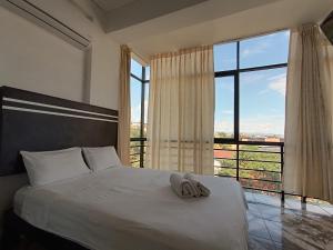 a bedroom with a bed and a large window at Hotel Valle Verde in Tarapoto +18 photos