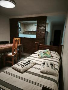 a bedroom with a bed with two pillows on it at Tesoro Escondido in Santa Rosa