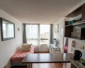 a small living room with a couch and a window at Metroapart 1 a un min del metro in Santiago