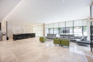 a lobby with couches and a fireplace in a building at 포항시티호텔 in Pohang