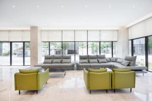 a lobby with couches and chairs in a building at 포항시티호텔 in Pohang +84 photos