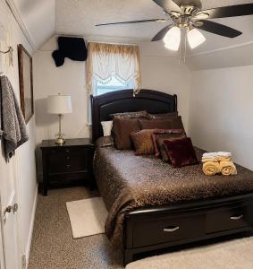 a bedroom with a bed and a ceiling fan at Luxury Pre-War Townhouse Bronx 5BR in University Heights