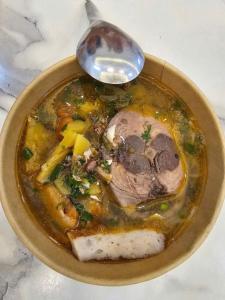 a bowl of soup with a spoon in it at Mom's house Lý Sơn in An Vĩnh Phướng