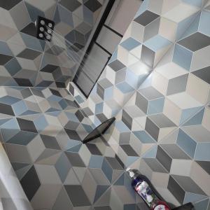 a bathroom with blue and white hexagonal tiles at Lima Airport Hostel - FREE AIRPORT PICK UP in Lima +82 photos