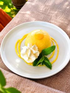 a white plate with a dessert on a table at Il Cerchio delle Streghe Country House al Podere Casella in Castiglione dʼOrcia