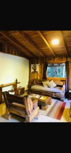a room with two beds and a chair in it at Logia Blanca in Villarrica