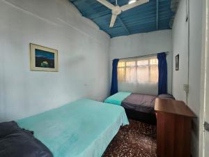 a bedroom with two beds and a table and a window at VILLA ELSA in El Colegio +10 photos