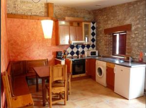 a kitchen with a table and a dining room at Posada El Pozo in Castanedo