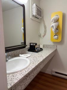 a bathroom with a sink and a mirror at Coastline Motel Kamloops in Kamloops +17 photos