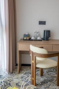 a desk with a chair next to a wooden table at The MAJULAN Hotel in Kota Kinabalu