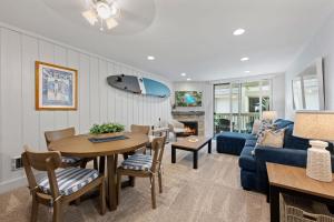 a living room with a blue couch and a table at G207 - Surfer's Hideaway in Oceanside