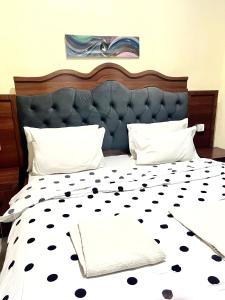 a bedroom with a bed with a black and white bedspread at KiGALI CLASSIC LODGE in Kigali