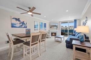 a living room with a dining room table and a couch at A217 - Blue Water Escape in Oceanside