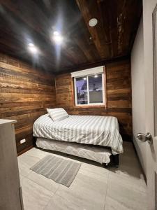 a small room with a bed and a window at Cabañas Laguna Magica in Valdivia +44 photos