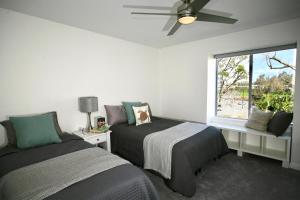 a bedroom with two beds and a window at A300 - Pier View Paradise in Oceanside +55 photos