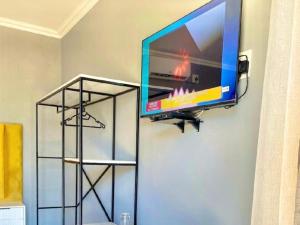 a flat screen tv hanging on a wall at MRF Lodge in Louis Trichardt