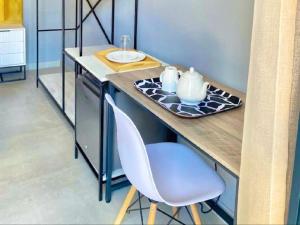 a kitchen counter with a table and a chair at MRF Lodge in Louis Trichardt