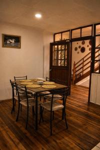 a dining room with a table and chairs and a staircase at Suite Colonial Patrimonio UNESCO Centro Histórico Cuenca in Cuenca