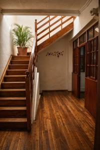 a staircase in a building with a potted plant at Suite Colonial Patrimonio UNESCO Centro Histórico Cuenca in Cuenca