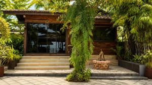 a wooden house with stairs and a tree at Mabini Sky View in Cebu City
