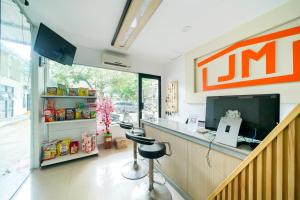 a mcdonalds restaurant with a counter and stools at JM Tuparev Mitra RedDoorz in Karawang