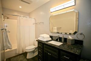 a bathroom with a sink and a toilet and a mirror at B306 - Endless Summer in Oceanside +14 photos